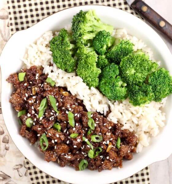 Ground beef and broccoli with rice on white plate
