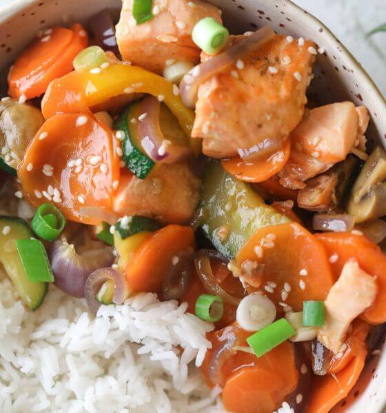 Salmon stir fry with white rice in bowl