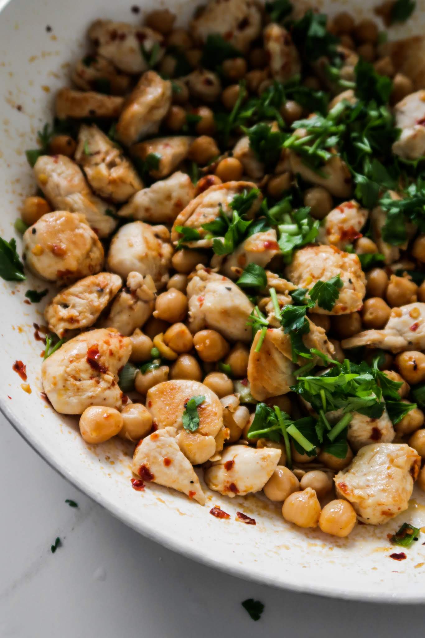 15-Minute Spicy Chicken and Chickpeas! Forget about chicken and rice, forget about chicken and broccoli (if you’re doing it to lose weight!) too! This easy healthy chicken recipe is the perfect dinner - it’s delicious, it’s spicy and you only one pan. Also it’s a very versatile and easy meal prep recipe that you can make in about 15 minutes. Pair with some fresh salad on the side and tzatziki or hummus and you’ve got yourself a tasty and healthy Mediterranean diet dinner in no time.